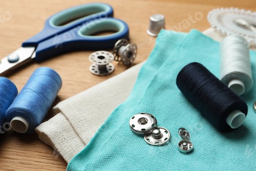 Preview: Spools of threads and sewing tools on wooden table