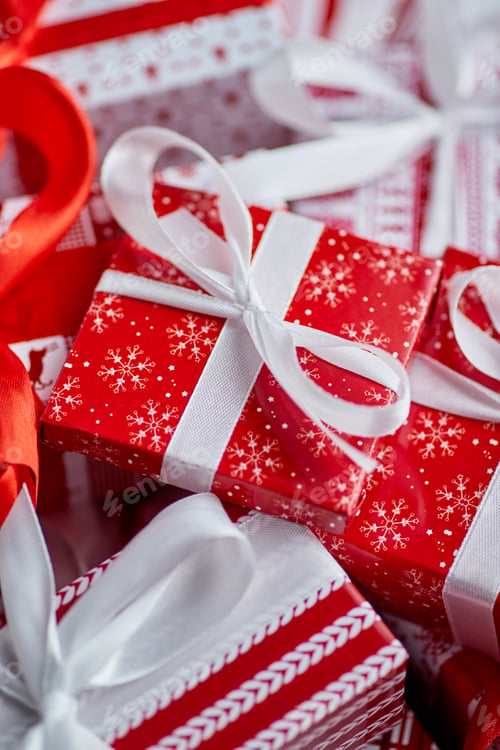 Preview: Christmas concept. Close up on festive paper wrapped gifts with ribbon