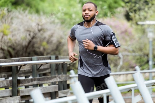 Preview: Fit and sporty young man running in the city.