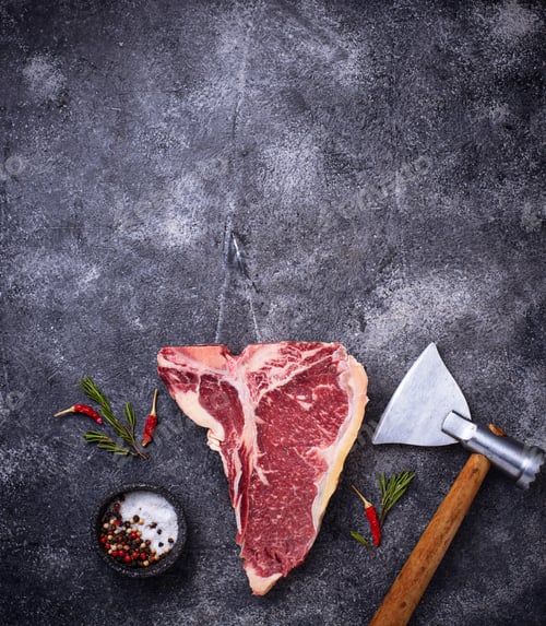 Preview: Raw T-bone steak with hatchet