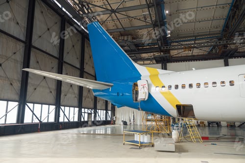 Preview: Airplane preparation for departure inside aircraft hangar indoors in the daytime