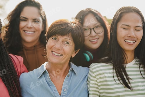 Preview: Group of multiracial women with different ages smiling in front of camera