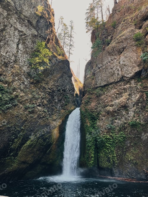 Preview: The sun peers through the rocks at Wahclella Falls in Cascade Locks, Oregon