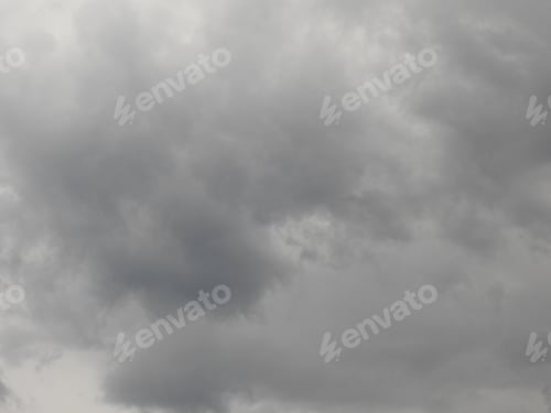 Preview: View of the cloudy sky with gray rain clouds at the sunset