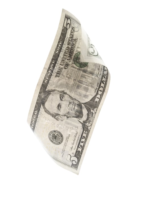 Preview: Five dollar bill floating in the air over a white background with crisp details