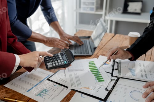 Preview: Group of businessmen working together to calculate income, They are revising the financial numbers,