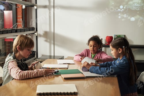 Preview: Multiethnic Children Collaborating on School Project at Classroom Table