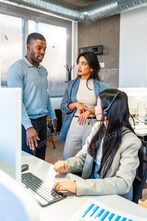 Preview: Coworkers discussing work in modern office with customer service representative