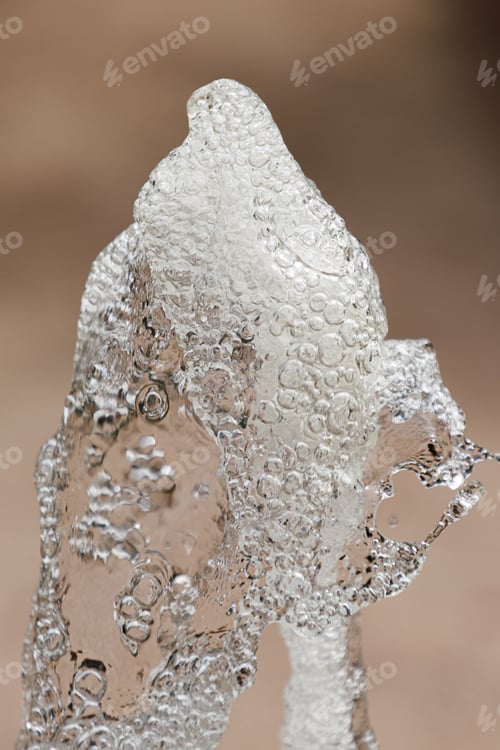 Preview: Vertical closeup of a drinking fountain with cascading water running down