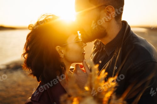 Preview: Enjoying time together. Stylish and loving couple enjoying each other by the sea.