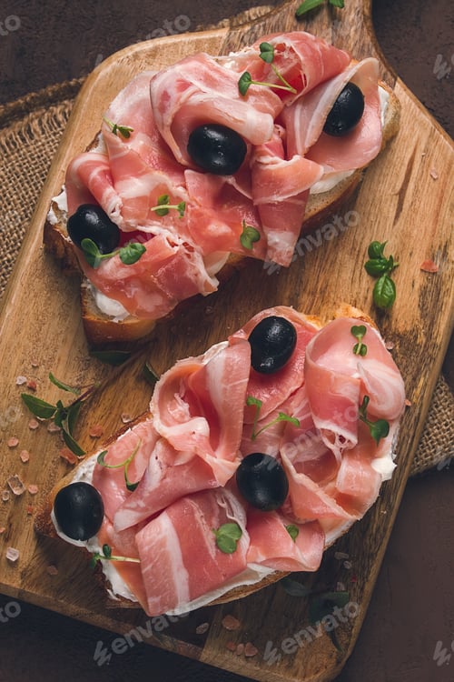 Preview: Breakfast, bacon and olives sandwich, on a cutting board, top view, close-up, no people,