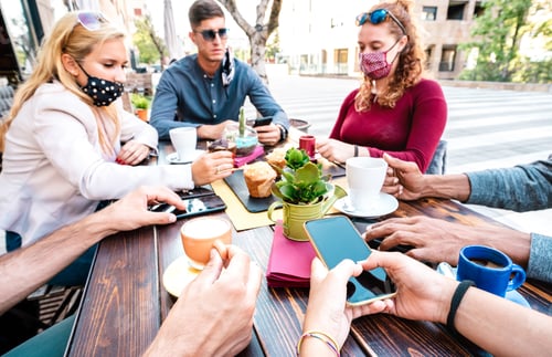 Preview: Bored people using mobile smart phones at coffee bar