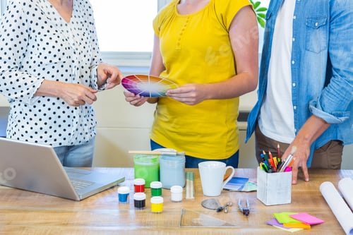 Preview: Casual business team discussing about colour chart in the office