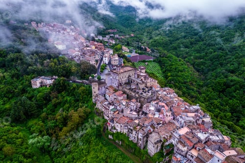 Preview: Aerial view of an ancient Italian village in lush green hills.