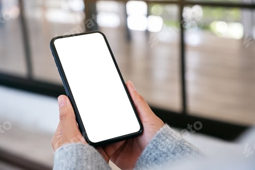 Preview: Mockup image of a woman holding black mobile phone with blank desktop screen