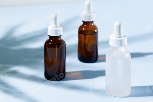 Preview: Glass jar with skincare liquid on gray background with shadow