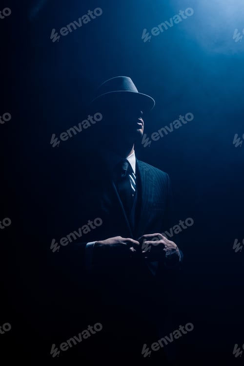 Preview: Silhouette of mafioso buttoning up on dark blue background