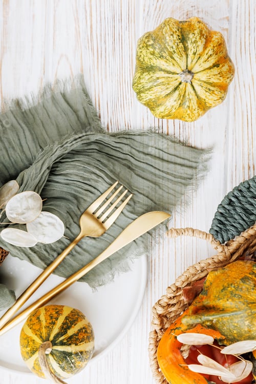 Preview: Autumn Gourds with Gold Cutlery on Wooden Table