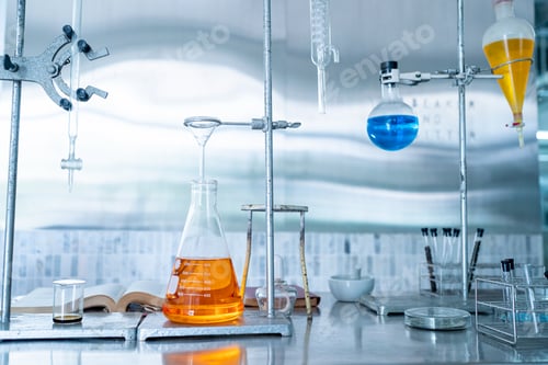 Preview: scientist doing research on plants holding a green solution in a test tube