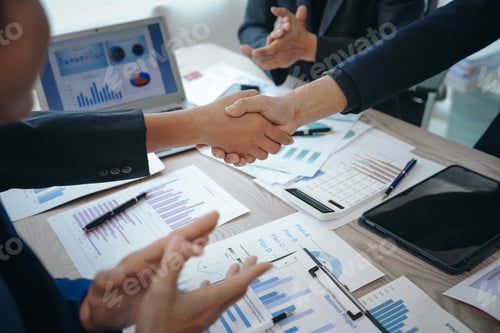 Preview: business team meeting, success is celebrated with handshake. Hands close up, dressed in formal suit
