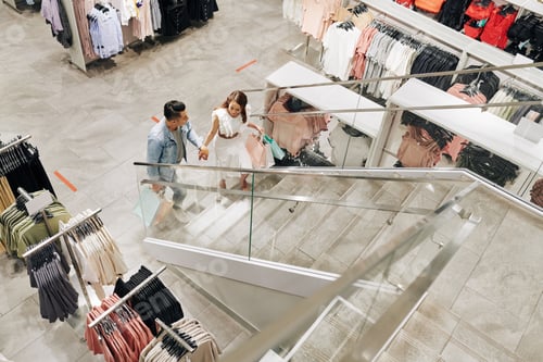 Preview: Couple making purchases in mall