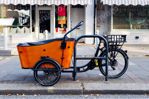 Preview: Orange cargo bike parked on a london sidewalk