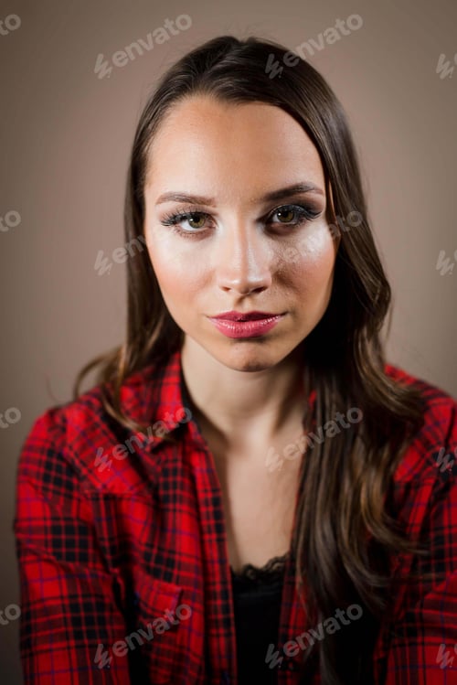 Preview: Portrait of a beautiful female with a po face on a brown background