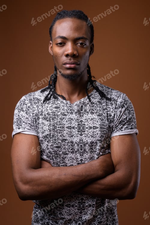 Preview: Young handsome African man against brown background