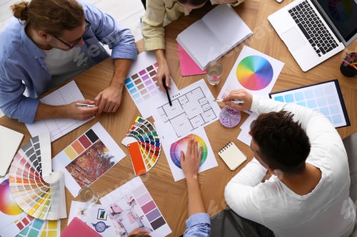 Preview: Professional team of interior designers working at table, top view