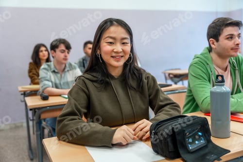 Preview: Smiling asian student attending a university lesson