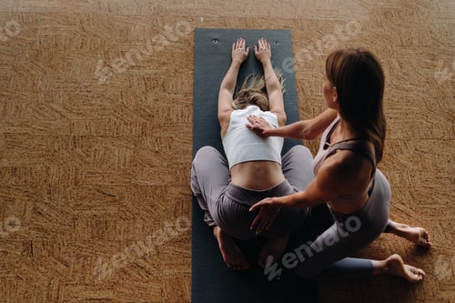 Preview: Yoga exercises. A personal trainer teaches a woman yoga classes in the gym