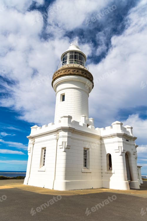 Preview: White lighthouse under a partly cloudy sky