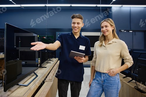 Preview: A Friendly Tech Store Interaction A salesperson actively assisting a customer with various TVs
