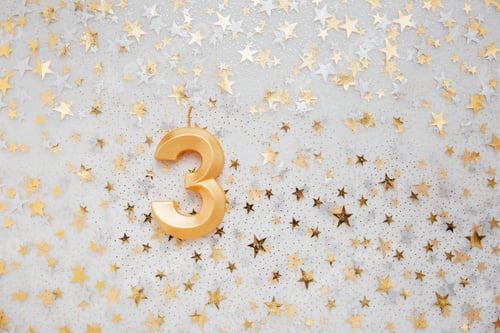 Preview: Number 3 three golden celebration birthday candle on Festive Background.
