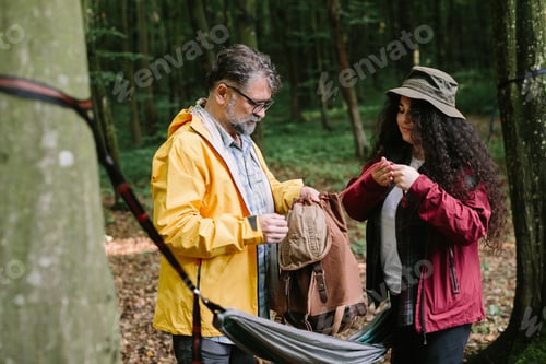 Preview: Father and daughter preparing hammock on nature hike