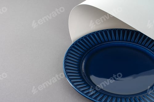 Preview: Glossy new ceramic dishware on paper background
