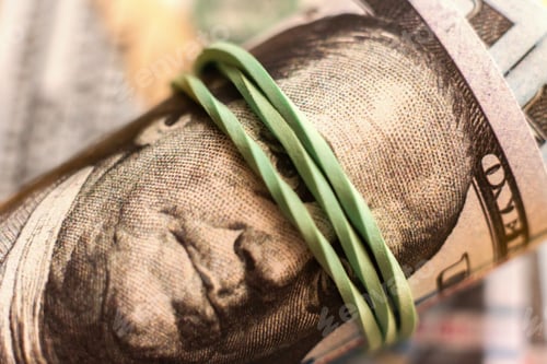 Preview: close up macro of paper currency roll of hundred dollars knitted by rubber band