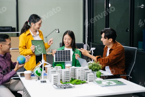 Preview: Group of diverse multiethnic businesspeople standing neare table looking at model of building from