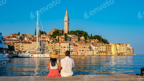 Preview: Couple enjoying a romantic sunset view of Rovinj's colorful coastal landscape in Croatia