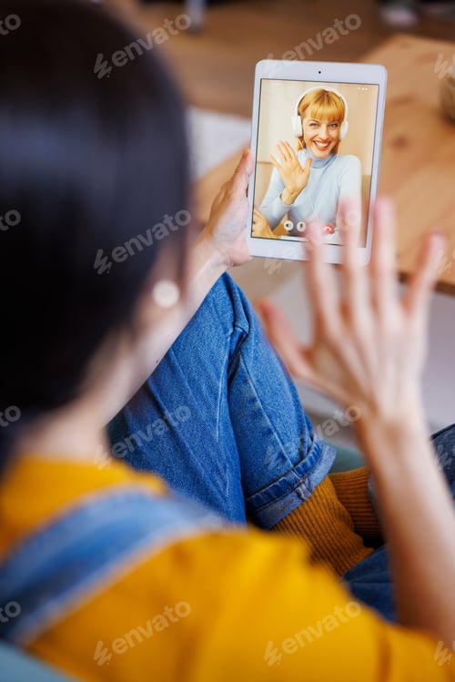 Preview: Woman having video call with friend using tablet computer