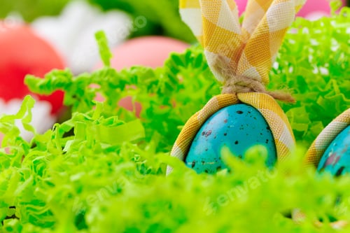 Preview: Colored Easter eggs on grass decorated with flowers