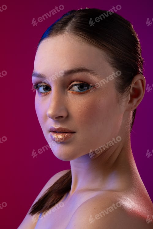 Preview: Portrait of caucasian woman wearing golden eye shadow and lipstick on purple background