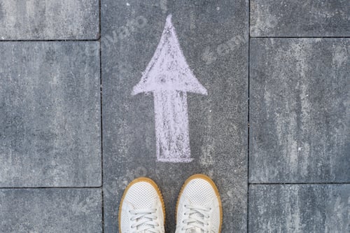 Preview: Feet and arrow on road.