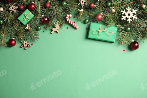 Preview: Fir tree branches with Christmas decoration on green background, flat lay. Space for text