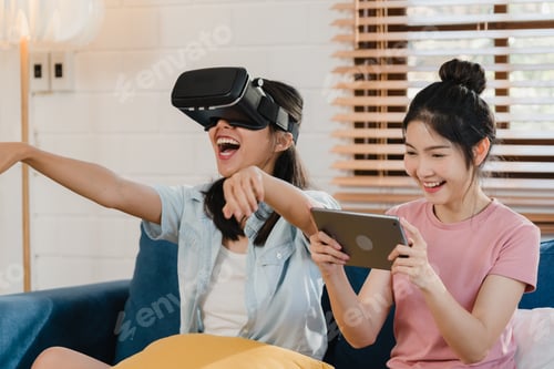 Preview: Young Lesbian lgbtq Asian women couple using tablet at home.