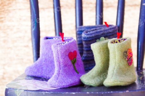 Adorable Baby Booties on a Blue Chair