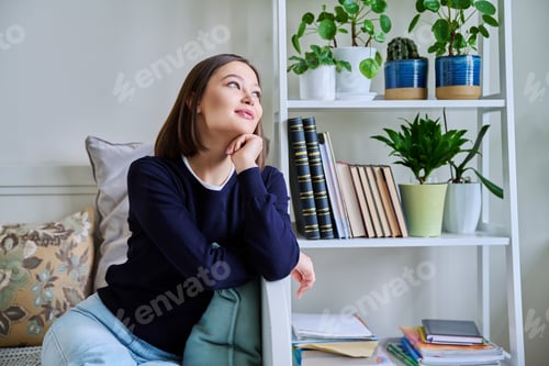 Preview: Portrait of young smiling woman in home interior