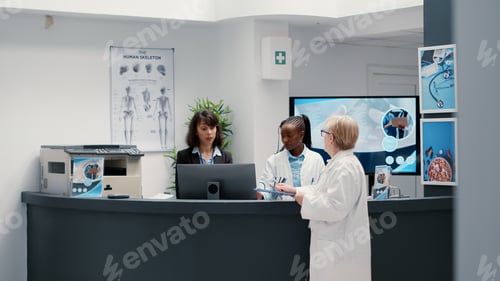 Preview: Senior physician talking to retired patient with impairment