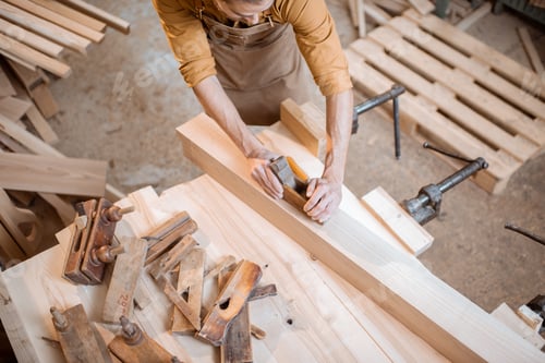 Preview: Carpenter working with a wood in the workshop