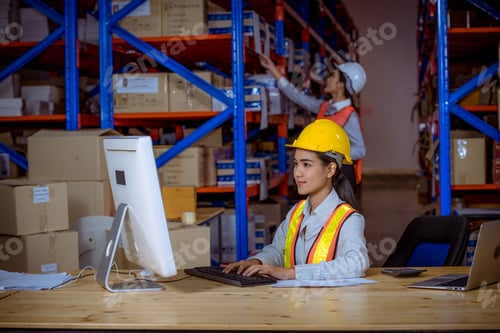 Preview: Industry manager and worker under discussion about production at factory warehouse. They wearing saf
